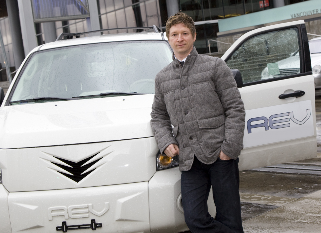 Jay Giraud standing near a REV vehicle that can connect to Auto Grid